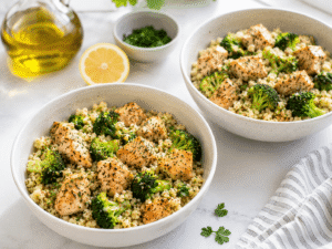 Chicken, broccoli, and cauliflower rice mixture divided evenly between two serving bowls.
