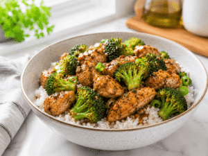 15-Minute Chicken Broccoli Bowl with tender chicken, fresh broccoli, and rice served warm in a white bowl.